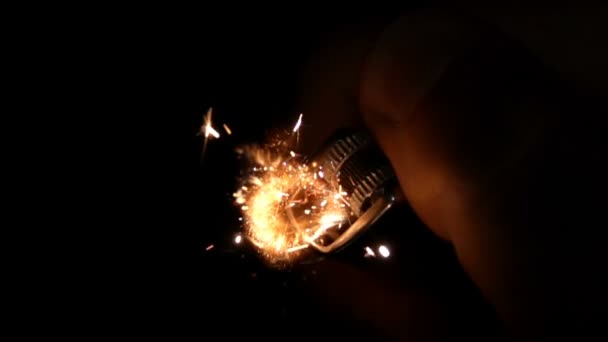À l'aide d'un briquet main sur un fond noir, au ralenti 