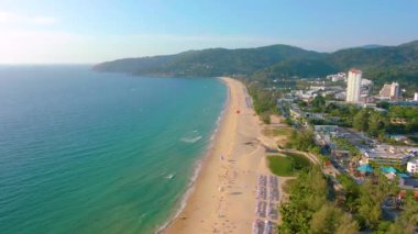 Hava 4k manzarası tropikal mavi okyanusun üzerinden güzel yeşil dağlara ve beyaz kumlu plaja doğru uçuyor. Tayland. Phuket. Karon plajı. Palms plajı. Ada manzaralı. Güzel tatil yeri.