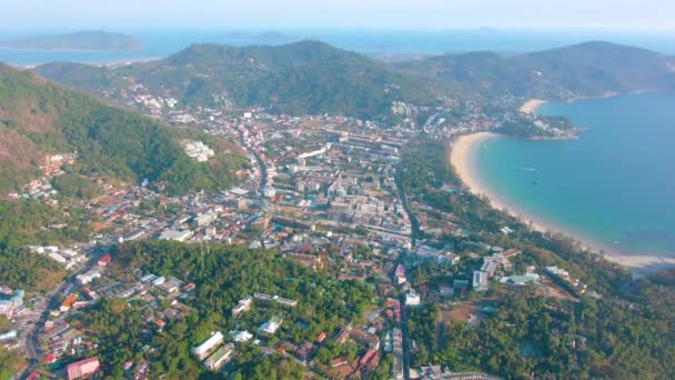 Aerial 4k view flying over tropical blue ocean towards beautiful green mountains and white sandy beach. Thailand. Phuket. Karon beach. Palms beach. Island top view. Beautiful resort place. — Stock Video