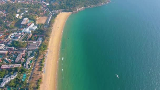 Aerial 4k view flying over tropical blue ocean towards beautiful green mountains and white sandy beach. Thailand. Phuket. Karon beach. Palms beach. Island top view. Beautiful resort place. — Stock Video