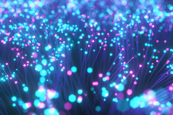 Fiber optic wires with flashing signals. Digital data transmission via fiber optic cable. Bouquet of colored optical fibers with bokeh. Technology concept. 3d illustration