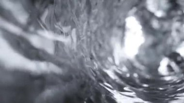 Su kadehte ağır çekimde hareket eder. Soyut su arka planı. Kusursuz 3D döngü oluşturucu
