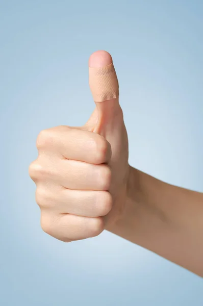 Plaster on female thumb — Stock Photo, Image