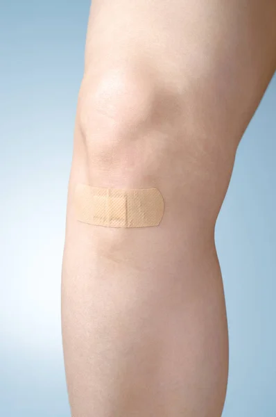 Plaster on female leg — Stock Photo, Image