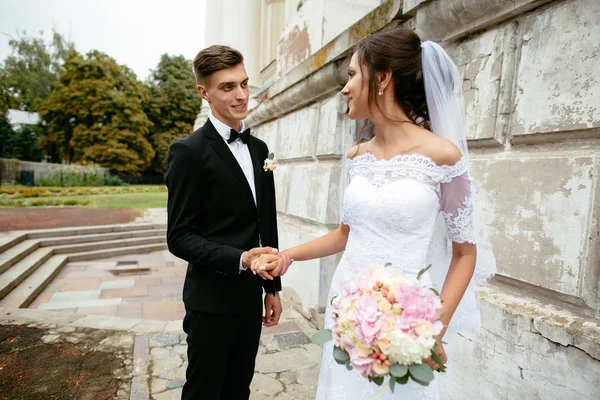 Día de la boda. Hermosos recién casados caminando después de la ceremonia de boda . — Foto de Stock