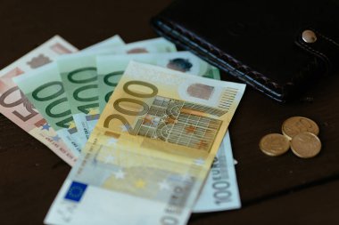 Euro para birimi. Euro banknot ve ahşap arka plan üzerinde erkek cüzdan ile euro cent. Ekonomi kavramı.