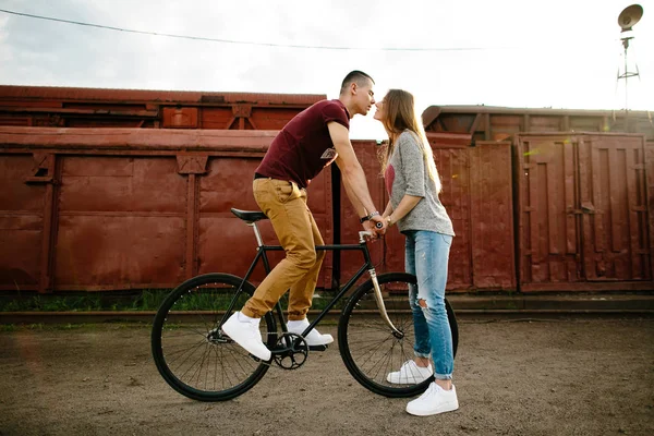 Young happy man on bike kissing own girlfriend — Stock Photo, Image