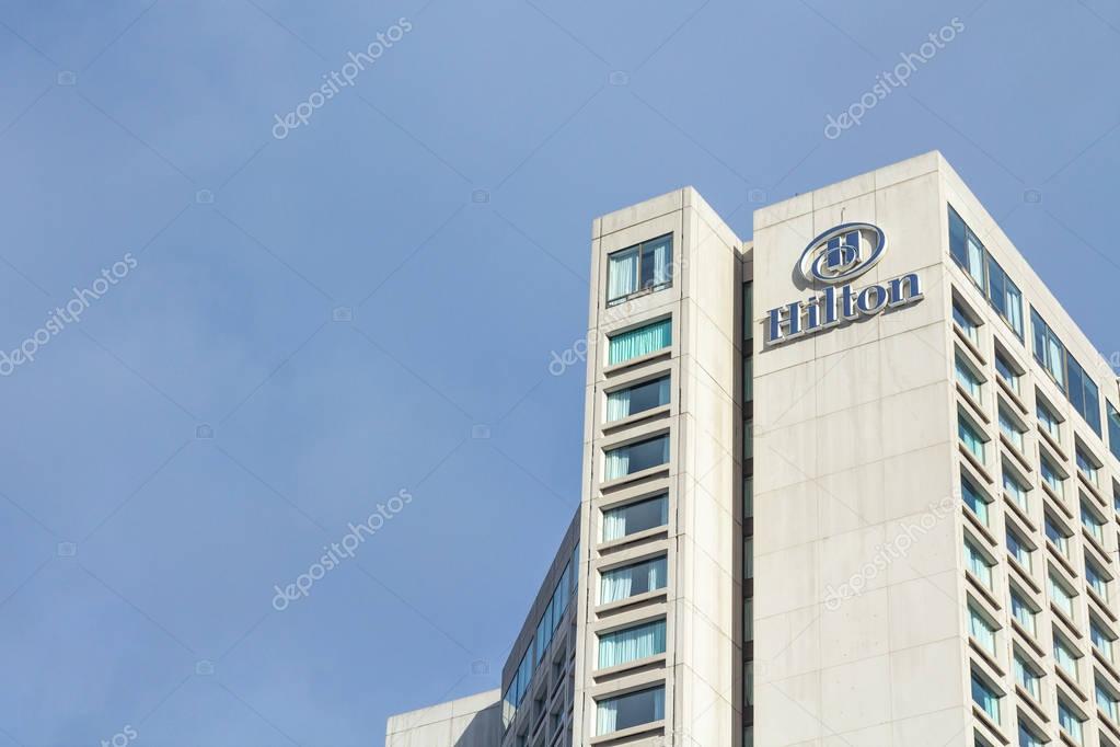 The Hilton Quebec, located on Parliament Hill, overlooks Canada's old city. This picture shows the main facade of the hotel, with its logo.