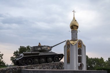 TIRASPOL, TRANSNITRIA (MOLDOVA) - AUGUST 12, 2016: Little Girl playing on the Tank Monument erected to commemorate the 1992 Transnitria civil war clipart