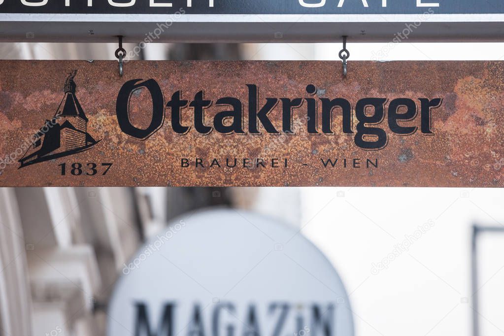 VIENNA, AUSTRIA - NOVEMBER 6, 2019: Logo of Ottakringer beer in front of a local bar and cafe in Vienna. Ottakringer bier is an iconic Austrial light beer, Helles type, from Ottakring district in Vienna