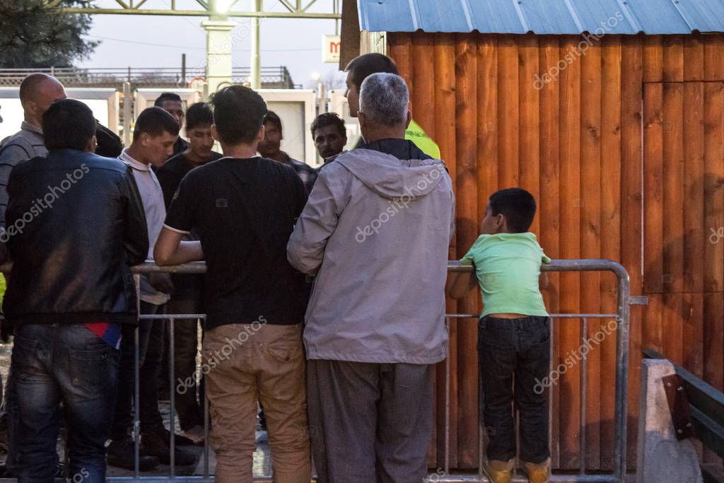 BELGRADE, SERBIA - APRIL 4, 2016: Refugees from Syria & Afghanistan, old & young men & children, waiting for aid & food at a shelter run by volunteers, on the Balkans Route, during  Refugee crisis
