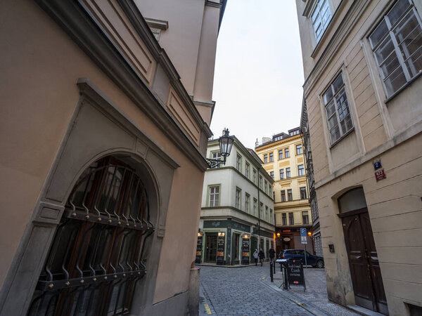 PRAGUE, CZECHIA - NOVEMBER 3, 2019: Kozna Ulice, a Narrow street of the old town of Prague, called Stare Mesto, with medieval buildings and cobblestone pavement, in the historical center
