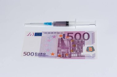 Syringe vaccine and euro bills. Expensive medicine concept.