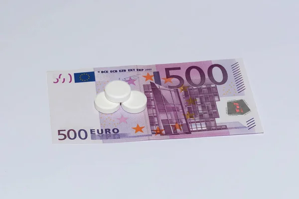 Tablets and euro bills. Expensive medicine concept.