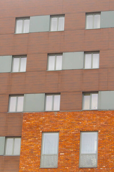 Gray windows on brick and modern walls. Old and new.