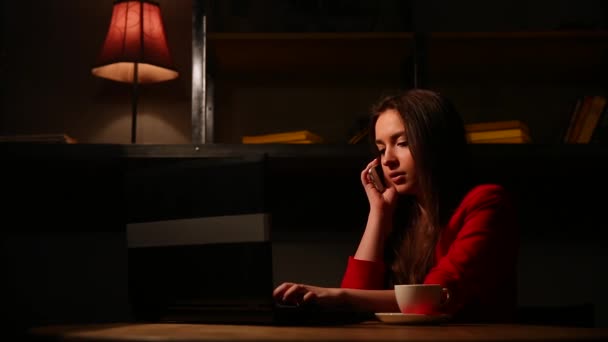 Dívka v červené bundě kouření elektronické cigarety a mluví o mobilní telefon. — Stock video
