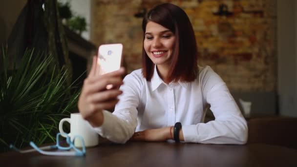 Casual young woman talking on phone having conversation via video chat conference at home office. Businesswoman using smart phone app on smartphone smiling happy — Stock Video