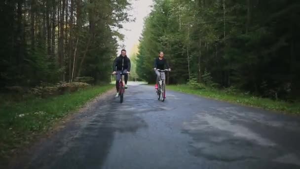 Happy couple riding bicycles outside, healthy lifestyle fun concept — Stock Video