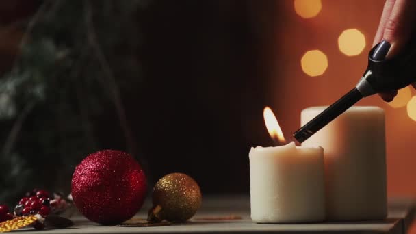 Close-up. Natal a mão de uma jovem mulher acende velas perto da árvore de Natal no fundo do fundo borrado — Vídeo de Stock