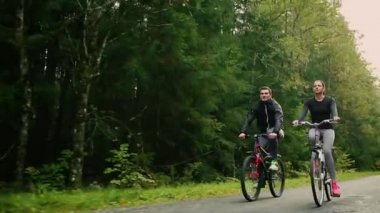 Bisiklet ve ormanın içinde içme suyu ile yürüme çekici çift