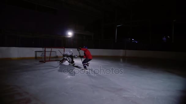 Eishockeyprofis spielen das Shootout. Der Spieler, der den Elfmeter hält, ist ein Eishockey-Torhüter. Schwebestativ. — Stockvideo