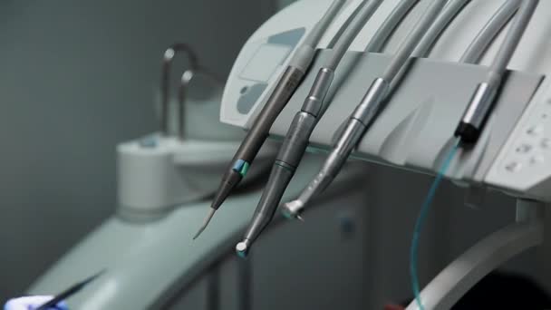 Female dentist and her nurse set the seal to the patient lying in the chair of a dental office. — Stock Video