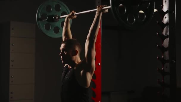 Sports inflated male performs the lifting weights performing standing exercise for the muscles of the shoulders. — Stock Video