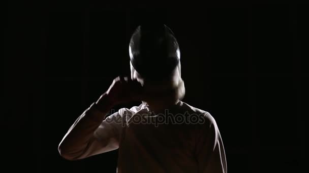 A man dressed for fencing wears a mask and is preparing a rapier. Close-up. The position to start sparring — Stock Video