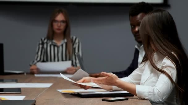 Una hermosa rubia sexy con gafas responde a las preguntas de los empleados en los gráficos durante el último año antes de la junta directiva — Vídeos de Stock