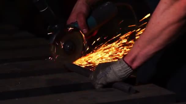 Closeup on electric saw and hands of worker with sparks. man working with grinder, close up on tool, sparks fly, real situation picture. — Stock Video