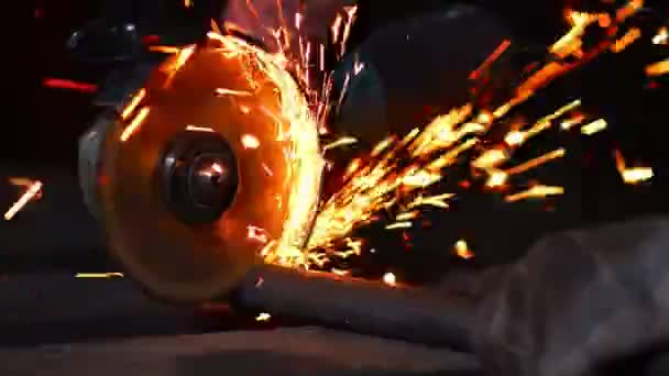 Closeup on electric saw and hands of worker with sparks. man working with grinder, close up on tool, sparks fly, real situation picture. — Stock Video