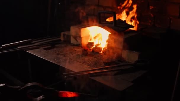 Hardening of the metal by sharp cooling in water. There is steam. The blacksmith tempers a red-hot sword on an old technology. Creation of ancient weapons. Blacksmiths Armory. — Stock Video