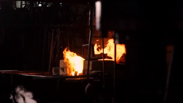 Hardening of the metal by sharp cooling in water. There is steam. The blacksmith tempers a red-hot sword on an old technology. Creation of ancient weapons. Blacksmiths Armory. — Stock Video