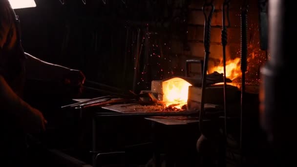 Hardening of the metal by sharp cooling in water. There is steam. The blacksmith tempers a red-hot sword on an old technology. Creation of ancient weapons. Blacksmiths Armory. — Stock Video