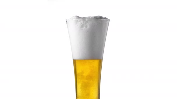 Arka plan beyazını köpüklerle kapatın. Bardakta bira, düşük açılı yan görüş, yavaş çekim.. — Stok video