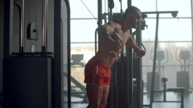Spor salonunda göğüs egzersizi yapan genç sporcu kablo çapraz makinası, motivasyon sağlık gücü sporu
