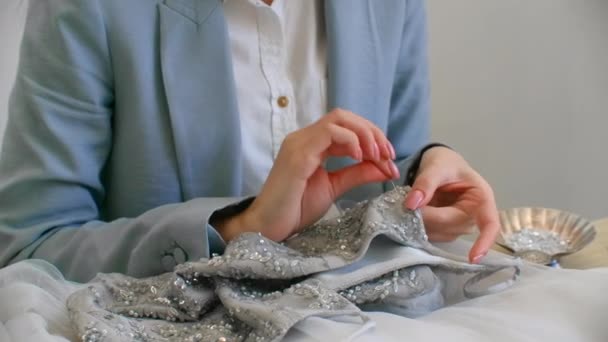 Handmade decorate the dress with crystals. Seamstress creates an exclusive dress — Stock Video
