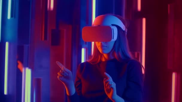Jeune femme mettant casque VR sur le spectateur dans les néons — Video