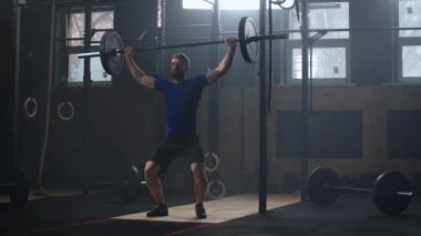 Male bodybuilder doing exercise with heavy weight bar. Full length of fitness man practicing deadlift at health club