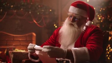 Magical Christmas atmosphere Santa Claus folds a parchment scroll and is going to deliver gifts to their homes