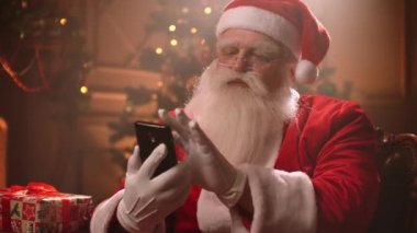 Santa Claus uses a smartphone and Internet applications.