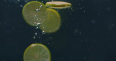 Lime rings Underwater with air bubbles and in slow motion. Fresh and juicy healthy vegetarian.