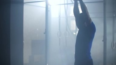 Slow motion: Man doing exercise with kettlebell in gym. fitness athletes men training muscular bodybuilders using kettlebell weights doing intense strength exercise in gym.