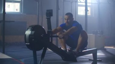 Yavaş çekim: fitness sporcusu kürek çekme makinesi yoğun dayanıklılık egzersizi spor sporcusu sağlıklı yaşam tarzı motivasyonunda güçlü bir fiziksel uygulama