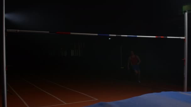 The man successfully performed a high jump over the bar. Slow motion — Stock Footage The man successfully performed a high jump over the bar. Slow motion Stock Footage
