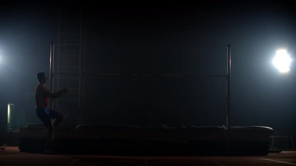 The man successfully performed a high jump over the bar. Slow motion — Stock Footage The man successfully performed a high jump over the bar. Slow motion Royalty Free Stock Video