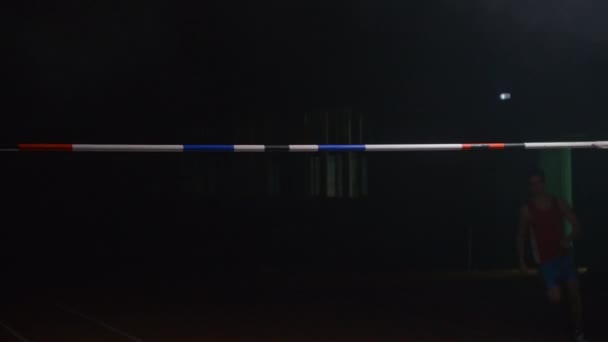 Slow motion: Male high jumper jumping over the bar and failure, error, hit the crossbar — Stock Footage Slow motion: Male high jumper jumping over the bar and failure, error, hit the crossbar Royalty Free Stock Video