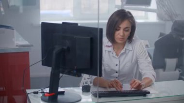 Hastanedeki kadın doktor röntgen görüntülerini ekrana yansıtıyor..
