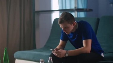 Heyecanlı adam kazananın elinde akıllı telefon var. İnternet haberlerini okuyor. Mobil online bahis bahisleri kazanıyor, mutlu adam cep telefonuna bakıyor..