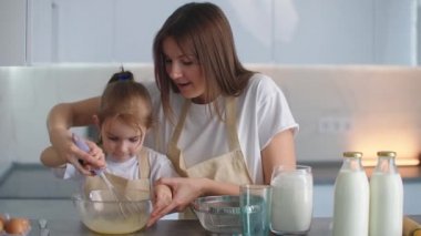 Anne kızına yemek pişirmeyi öğrenmesinde yardım ediyor. Mutfakta önlükler içinde, hamur yoğurup döverek ilerideki turta ve aladiy için yoğururlar. Birlikte ev yemeği..